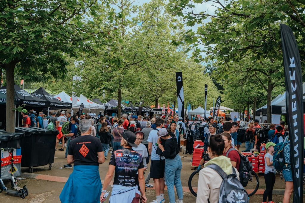 A crowd of people walking around a park