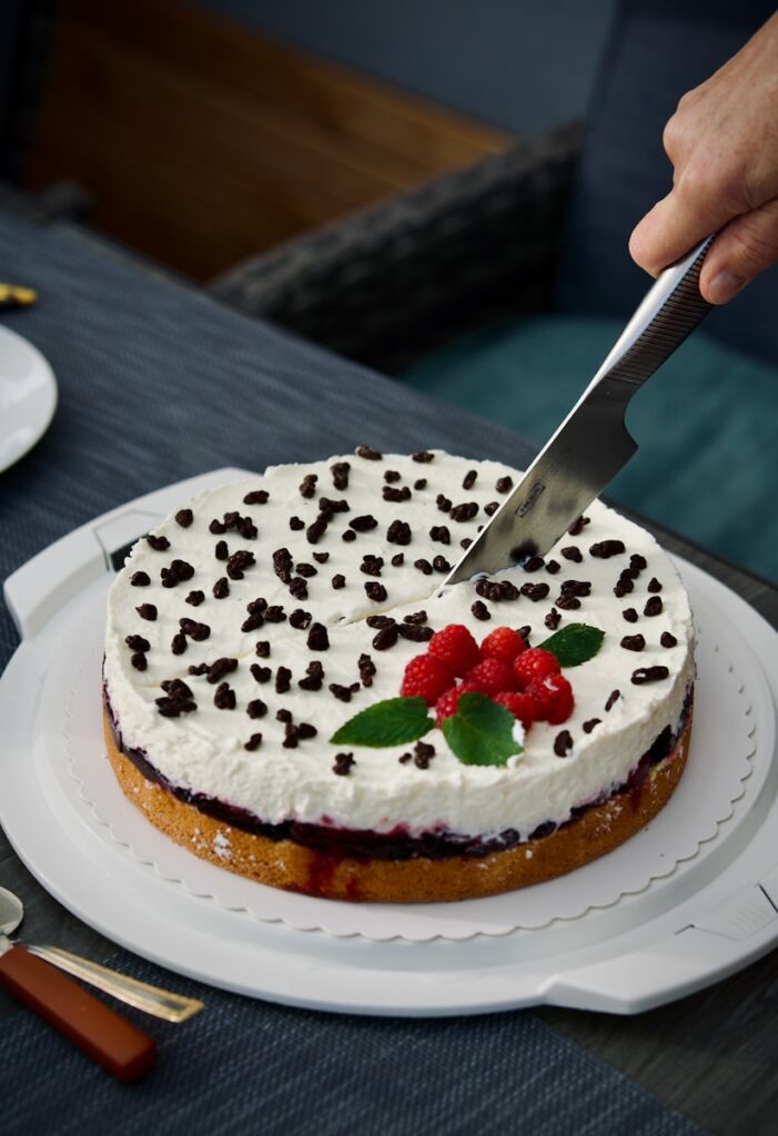 a person cutting a cake with a knife