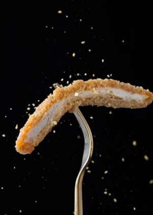 stainless steel fork with sliced breaded meat