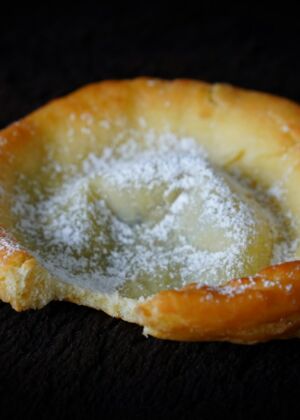 A pastry with powdered sugar on top of it