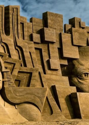 A sand sculpture of a group of heads