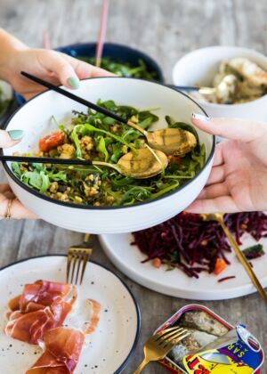 person holding white ceramic bowl with vegetable dish