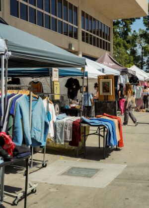 a group of people shopping at a flea market