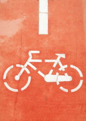 a bicycle sign painted on the side of a building