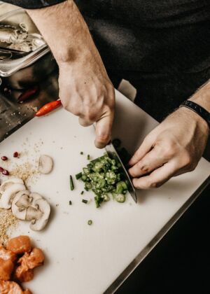 person slicing vegetable